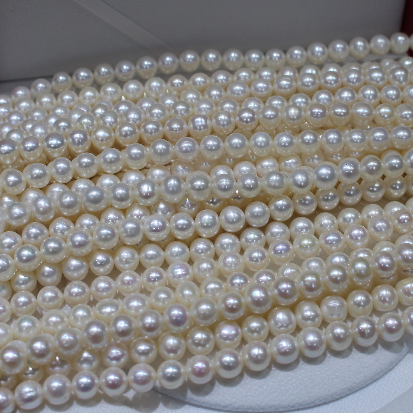 White color near round freshwater pearl strands