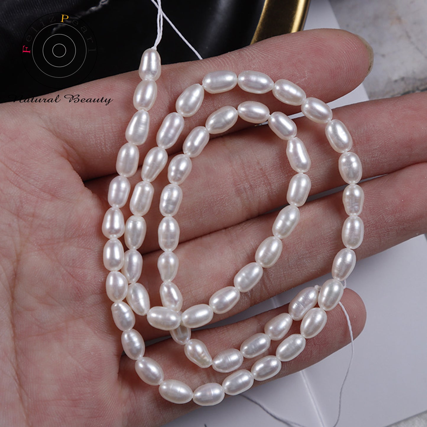white cultured rice pearl strand